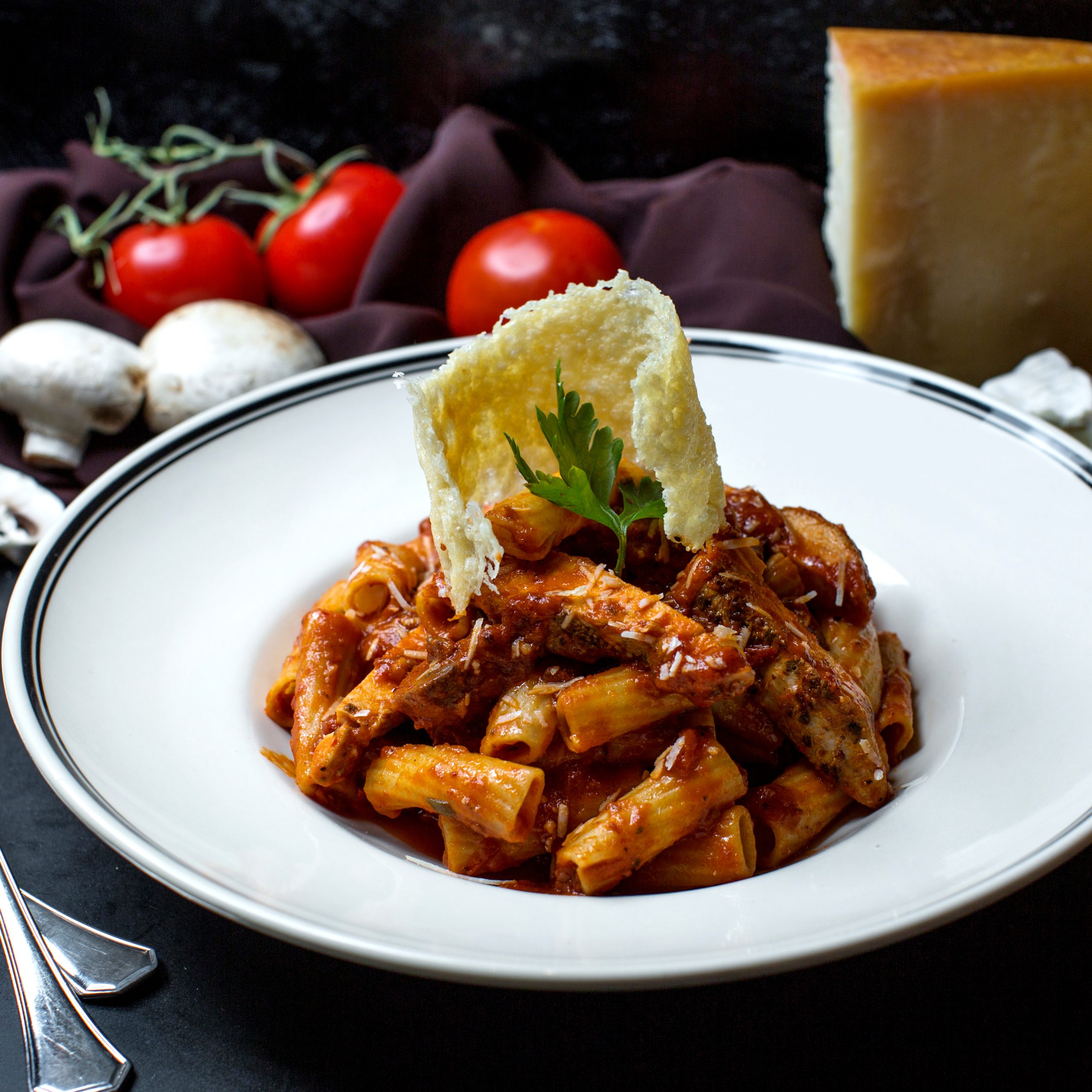 pasta with chicken in tomato sauce and grated cheese