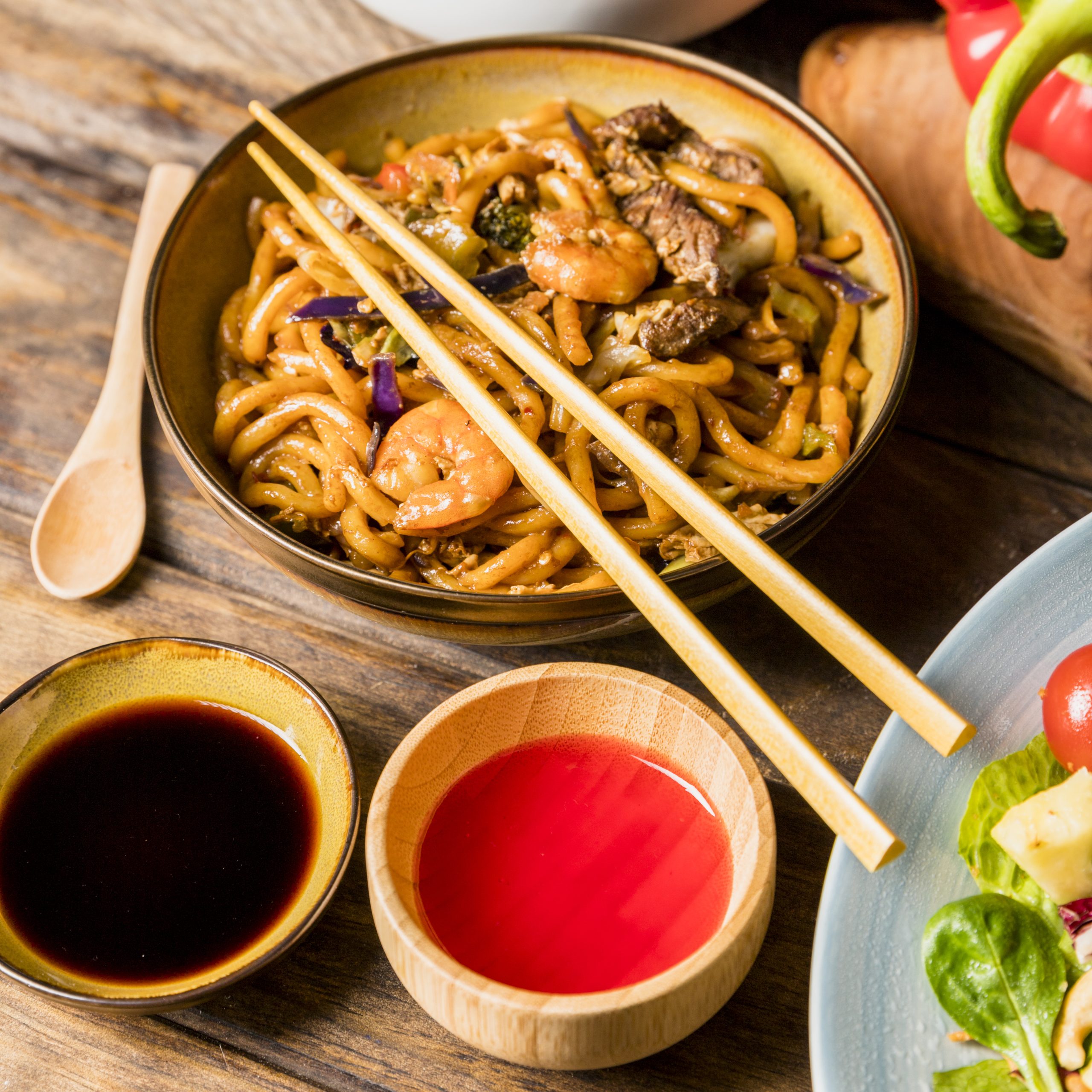 soya-red-chili-sauce-bowl-with-udon-noodles-chopsticks-table
